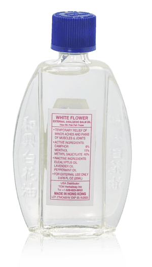 Minyak Angin White Flower Embrocation bottle backside label with usage, active ingredients, inactive ingredients, caution statement, USA distributor, and manufacturer information.