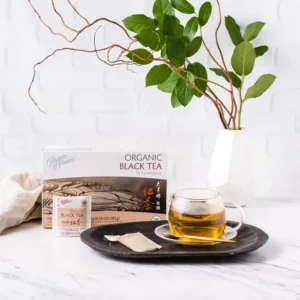 Image of the box and a cup of Prince of Peace Organic Black tea with aesthetic background