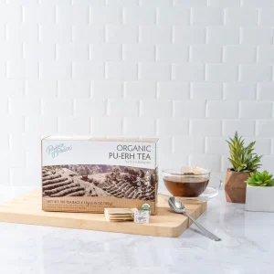 image of box and a brewed cup of Prince of Peace Pu-Erh tea with aesthetic background